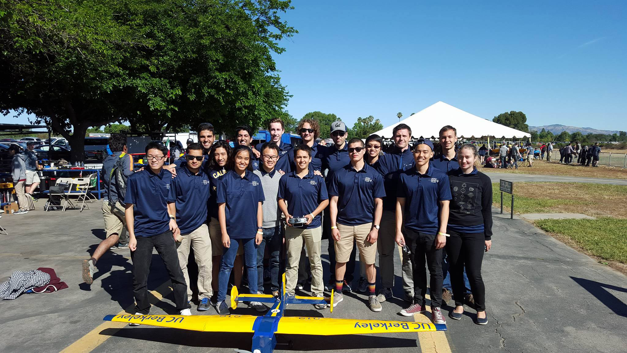 Cal Aero SAE team with their blue and gold aircraft at the airfield